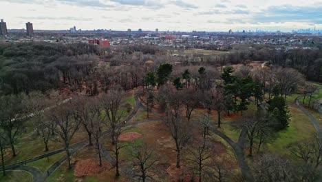 Drone-flying-over-Kissena-Park-in-neighborhood-of-Flushing-in-Queens,-New-York-City