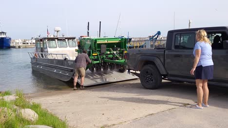 Loading-small-ferry-to-send-farm-equipment-to-island-in-Lake-Michigan