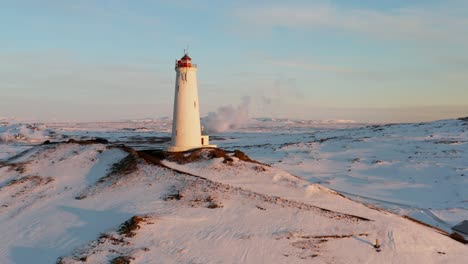 Golden-hour-glow-shining-on-Reykjanesviti-Lighthouse-in-Iceland-during-winter