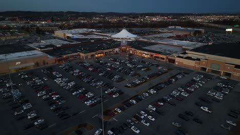 High-aerial-orbit-of-full-parking-lot-at-American-mall