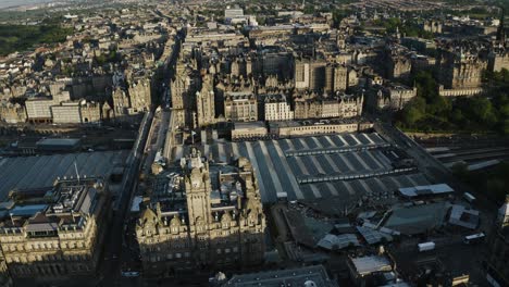 Rising-aerial-view-of-The-Balmoral-clock-tower-to-reveal-how-large-Edinburgh's-downtown-sector-is
