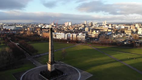 Drone-shot-flying-past-the-Nelson-Monument-on-Glasgow-Green-in-Glasgow,-Scotland