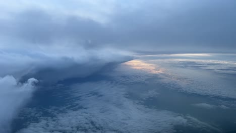 Stunning-view-from-a-jet-cockpit-while-flying-near-a-huge-cumulonimbus-just-after-dawn