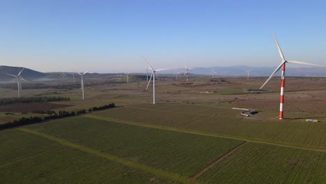 Low-level-drone-shot,-operating-wind-turbine-farm-generating-electricity,-Israel