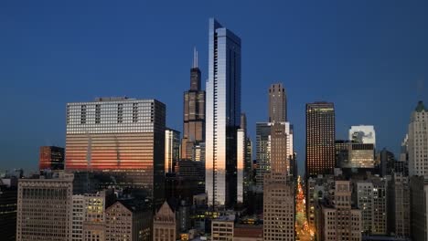 Aerial-view-around-the-reflecting-Legacy-tower,-dusk-in-Chicago,-USA---orbit,-drone-shot