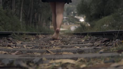 Girl-walking-on-the-train-rails