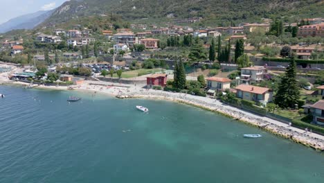 Aerial-shot-slowly-approaching-the-shores-of-the-beautiful-Italian-town-of-Malcesine