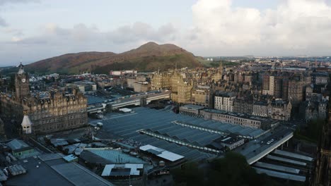 Aerial-shot-pushing-over-the-Waverley-Train-Station-and-into-Edinburgh's-downtown-buildings