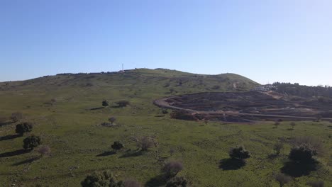 Low-level-drone-flyover-of-rocky-barren-landscape-on-slope-of-Mount-Odem,-Israel