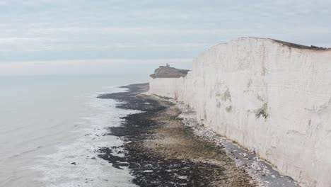 Long-drone-shot-towards-belle-tout-light-house-along-White-cliffs-UK