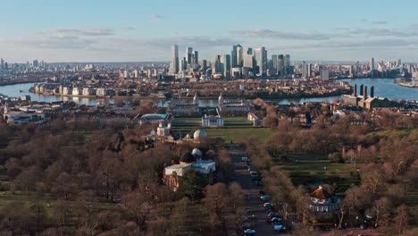 Dolly-forward-aerial-drone-shot-of-Greenwich-observatory-university-towards-Canary-wharf-skyscrapers