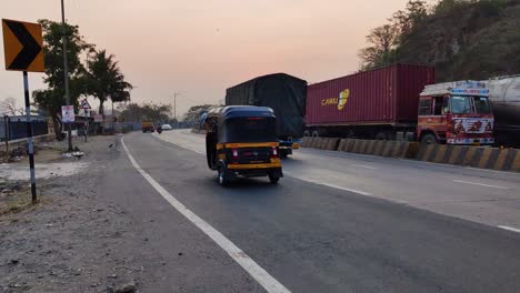 One-sided-Heavy-traffic-on-Indian-highway,-one-side-is-free-way-Indian-roads-with-heavy-trucks-and-vehicles-with-containers-and-goods-moving-very-slowly,-Indian-road-transportation-with-traffic