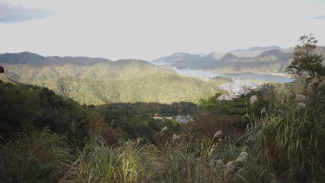 Mountainside-of-Hyogo-Japan,-Kinosaki-Onsen-in-the-Background