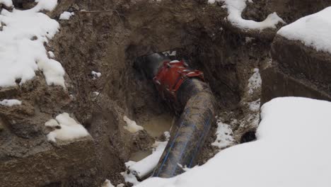 Underground-Pipeline-Of-A-Water-Or-Sewer-System-At-Winter-On-A-Snowy-Day