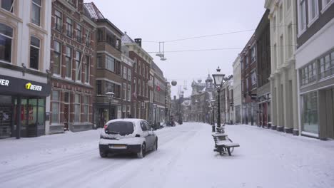 Leiden-city-buildings-and-Breestraat-road-covered-in-winter-snow,-Netherlands