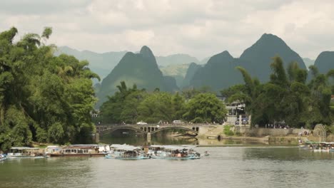 Bridge-over-the-Li-river-with-cars-people-and-boats-Guilin-China