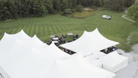 Wedding-celebration-in-luxury-white-tent-in-aerial-above-drone-view