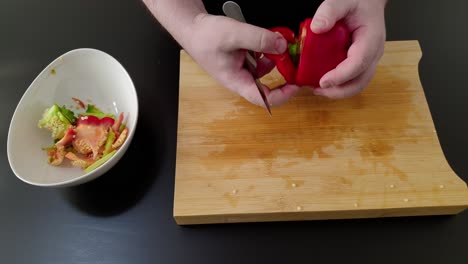 Preparing-red-Bell-pepper,-cutting-and-removing-seeds-and-core,-high-angle-studio-shot