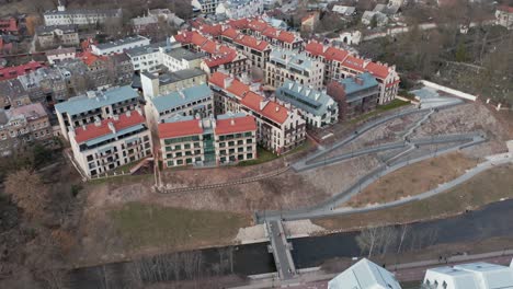 AERIAL:-New-Building-with-Red-Rooftops-District-in-Uzupis-Republic-in-Vilnius-near-River-Vilnele