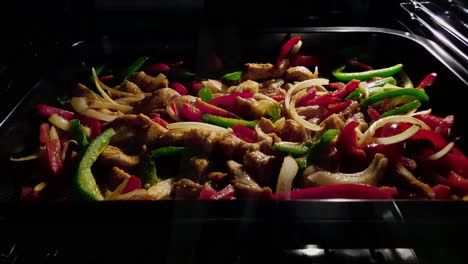 Close-up-of-chicken-fajitas-cooking-in-oven.-Timelapse