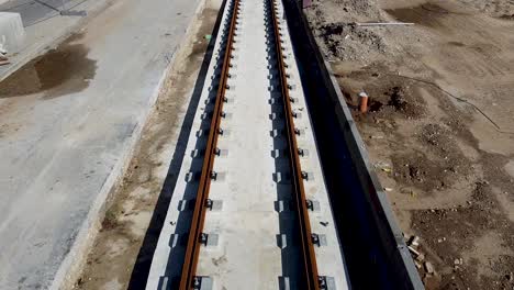 Aerial-forward-drone-shot-of-an-empty-light-rail-tracks-on-construction-in-Jaffa,-Israel