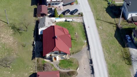 Street-with-Detached-Villa-Homes-in-Slovenian-Village,-Top,-Aerial-Backward