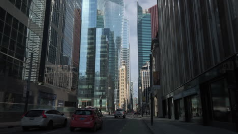 Wide-point-of-view-shot-cycling-through-the-downtown-core-of-Toronto