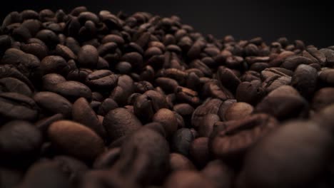 Macro-probe-shot-of-coffee-beans-on-black-background-for-copy-space