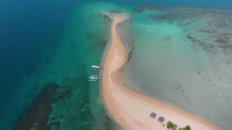Aerial-shot-of-a-Sandbar-with-boats-waiting-and-people-swimming