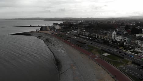 Drone-footage-of-Morecambe-flying-out-to-sea-in-Lancashire,-UK