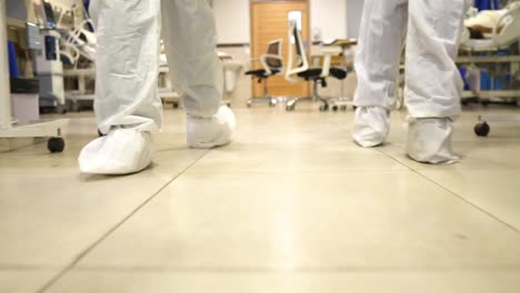 Médicos-Con-Equipo-Completo-De-Protección-Personal-Caminando-Por-La-Sala-De-Cuidados-Intensivos