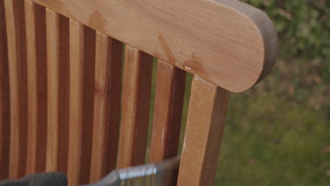 Close-up-shot-of-oiling-up-a-wooden-chair-for-the-new-season