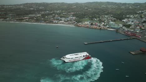 Close-up-aerial-view-in-slow-motion-of-a-passenger-inter--island-ferry-docking-on-the-Caribbean-island-of-Tobago