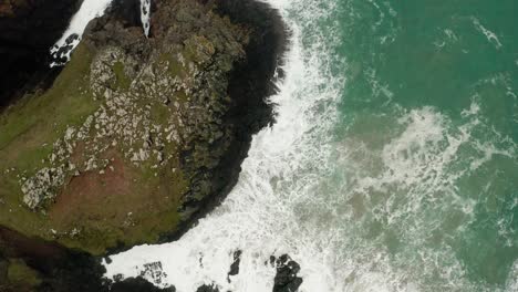 An-aerial-overhead-orbit-of-the-waves-from-the-Atlantic-crashing-into-the-shores-of-Cornwall,-England