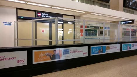 static-shot-of-an-empty-airport-exit-in-Malta,-advertisement-banners-are-on-the-walls