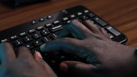 African-American-man-typing-on-a-computer-keyboard