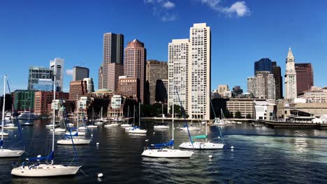 Boston-skyline-panning-from-board-of-a-ship-with-view-of-Inner-Harbor,-small-boats-and-the-skyline-of-downtown-Boston-financial-district