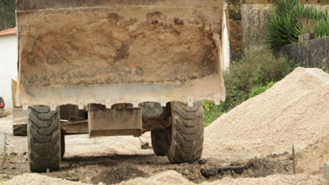 Excavadora-En-El-Trabajo-Descargando-Arena-En-El-Sitio-De-Construcción-De-Carreteras-En-Leiria,-Portugal