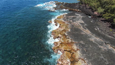 Blue-ocean-crashing-on-basalt-shoreline