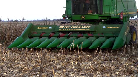 Detail-of-a-combine's-header-in-a-harvested-corn-field