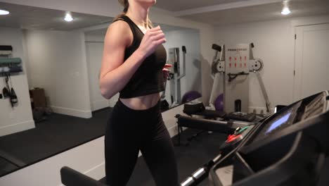 caucasian-blonde-woman-running-on-Bowflex-treadmill-indoors,-tilt-up