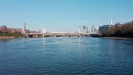 Dolly-forward-rising-reveal-shot-of-London-over-Chelsea-Bridge