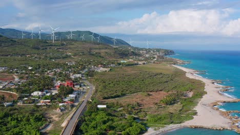 Aerial-forward-of-Barahona-wind-turbines-in-front-of-ocean-coast,-Dominican-Republic