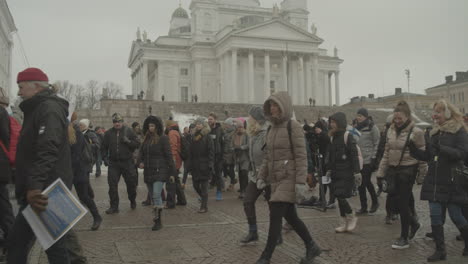 Huge-crowd-of-protesters-walk-during-a-peaceful-protest-in-from-of-Helsinki-Cathedral-on-a-cold-winter-day