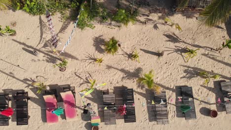 Beach-Chairs,-Hammocks-and-Palm-Trees-on-a-Hippie-Rasta-Beach-Bar,-Topshot