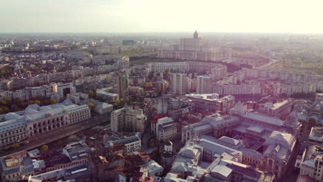 Beautiful-cinematic-aerial,-Bucharest-city-centre-skyline,-lens-flare