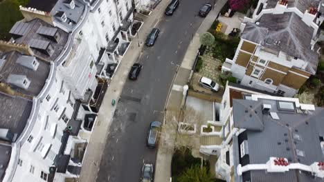 Aerial-flyover-road-with-parking-cars-and-white-apartment-houses-in-Notting-Hill-District-of-London