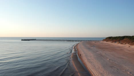 AERIAL:-Palanga-Bridge-with-Baltic-Sea-during-Golden-Hour-in-Evening