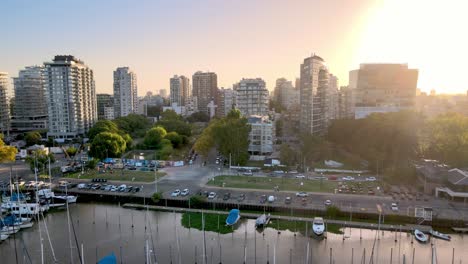 Aerial-dolly-out-of-Olivos-neighborhood-buildings-and-yachts-dock-inline-in-port-at-golden-hour,-Buenos-Aires