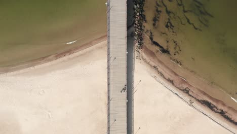 AERIAL:-People-Walking-on-Palanga-Pier-Towards-Baltic-Sea-on-Day-Time